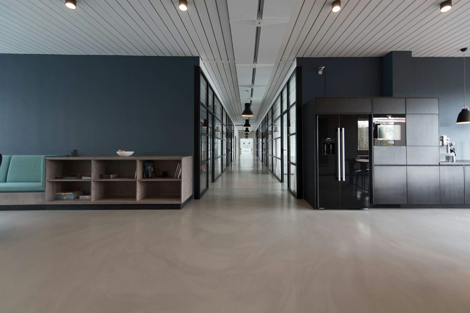 Calm modern office space with glass-walled corridor