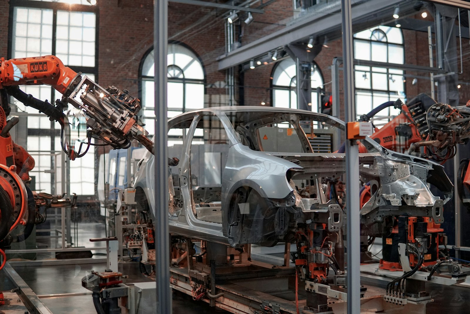 Car body on an assembly line surrounded by industrial robots